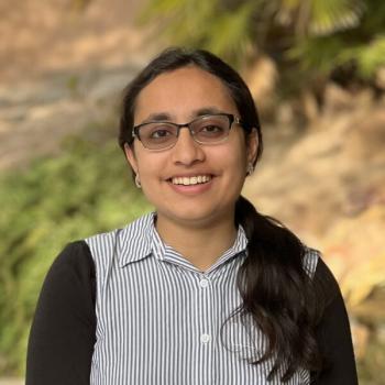 Abeerah faces the camera and smiles at the camera.