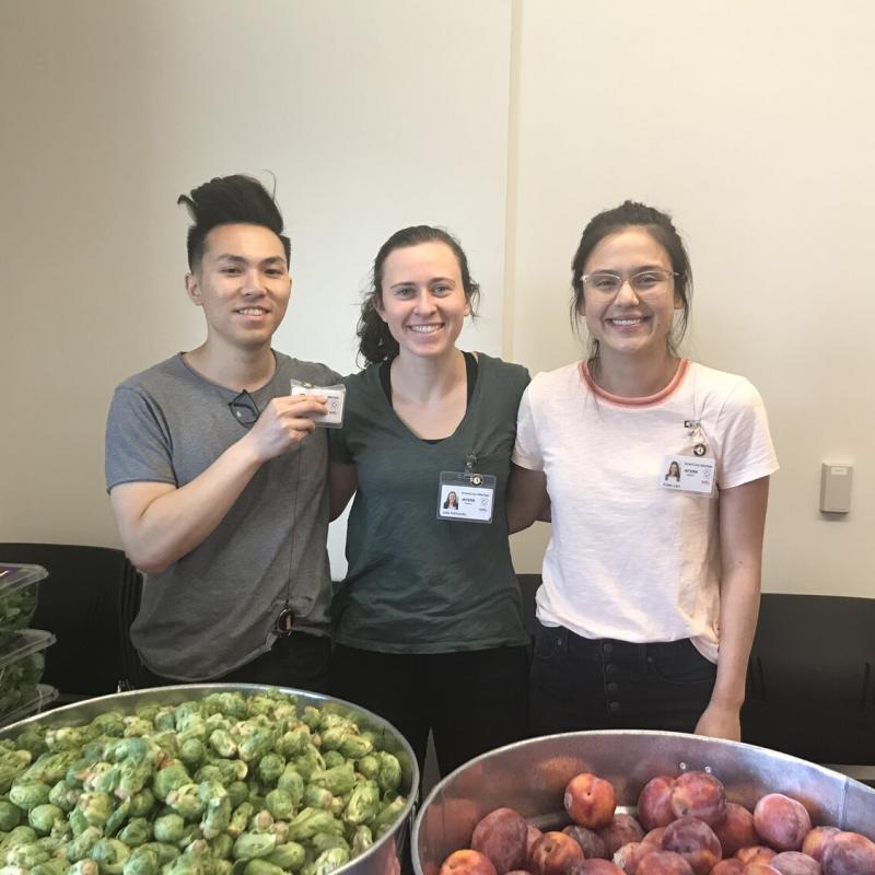 Wesley Ho, Julia Schroeder, and Kristin Lam serving at a food pantry.