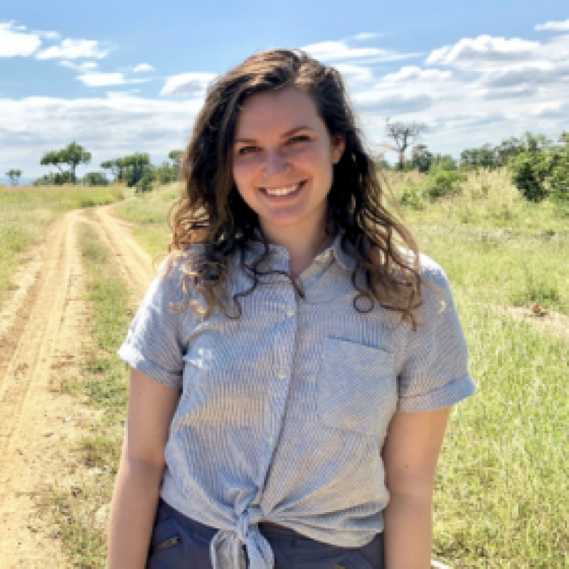 NHC PGH member Emily smiling on a sunny day in the countryside 