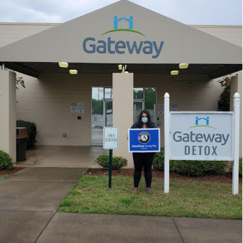NHC member Roya stands outside the entrance to the Gateway Detox Building.