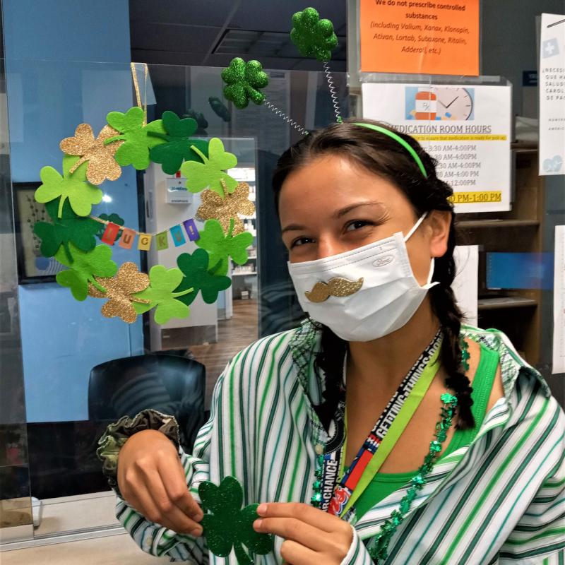 carol wearing a shamrock headband and surrounded by other st patricks day decor