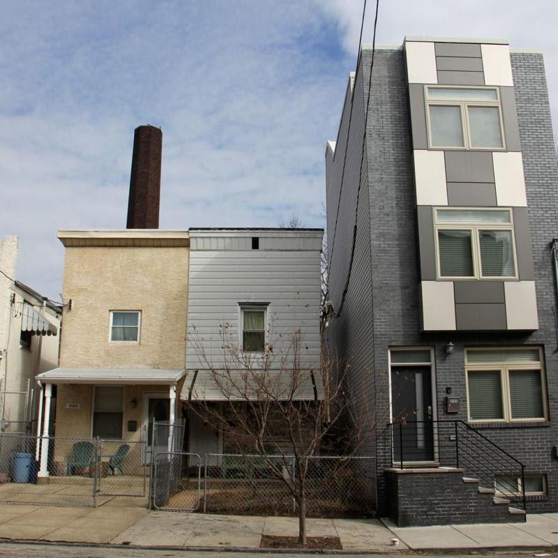 four row homes in east kensington with one that stands out as new development increases