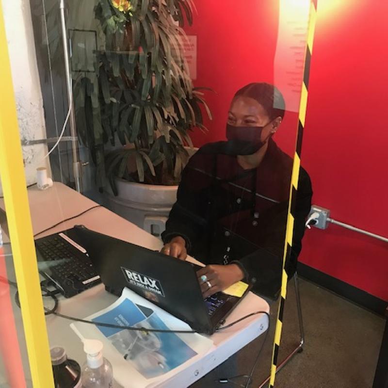 Brianna Bingham sitting in front of a computer during her service. 