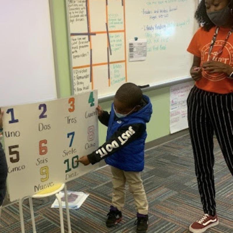 Kimberly teaching a Tiger Academy student numbers in Spanish.