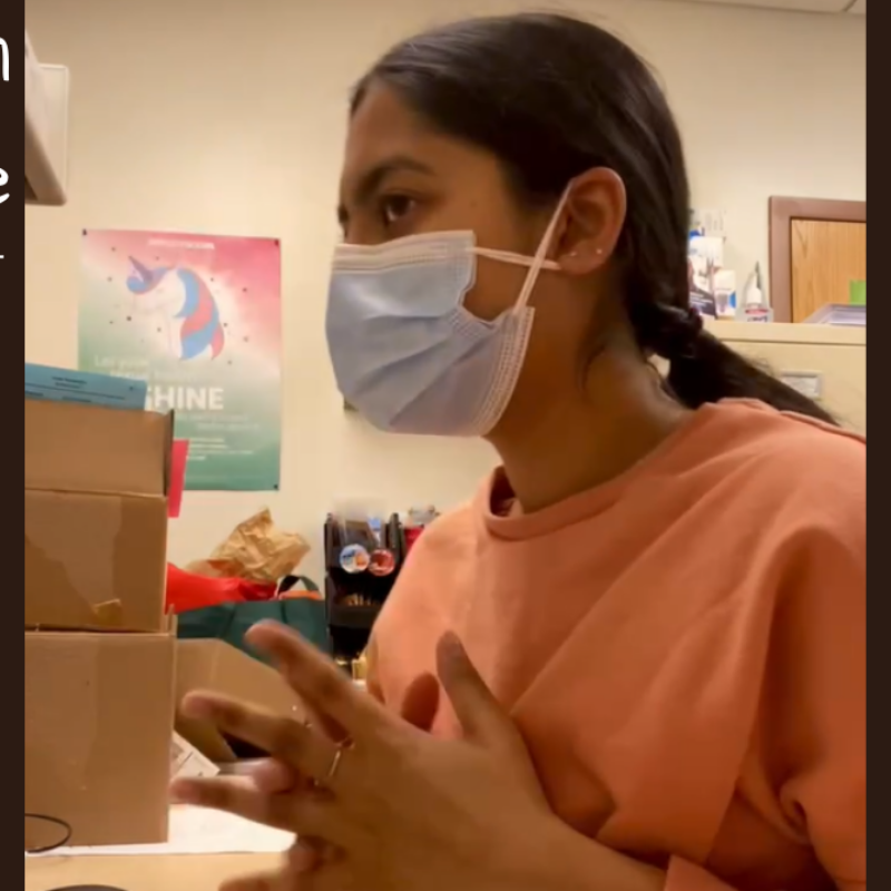 NHC member Pradhita sitting at her desk while on a call with a patient