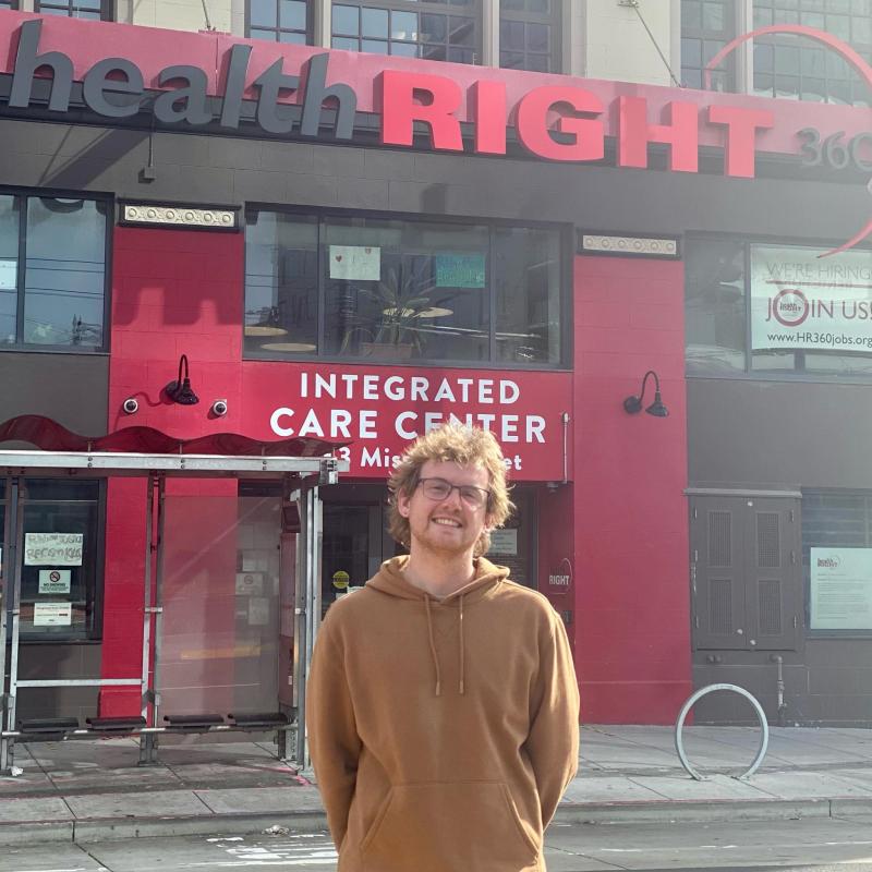 Will stands in front of the entrance to HealthRIGHT 360's Integrated Care Center.