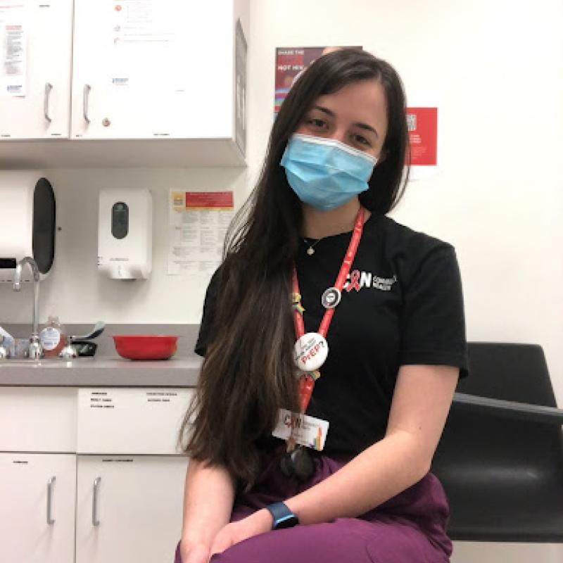 Marie Feliu is pictured sitting in an exam room where she conducts HIV, Hep C, and  STI testing. 