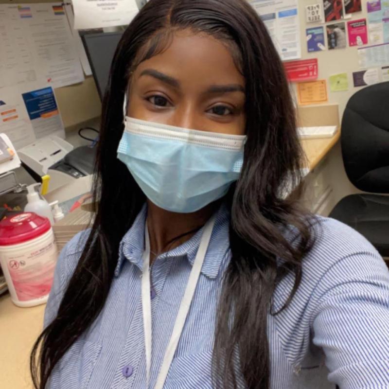 A selfie of Ami wearing a blue medical mask