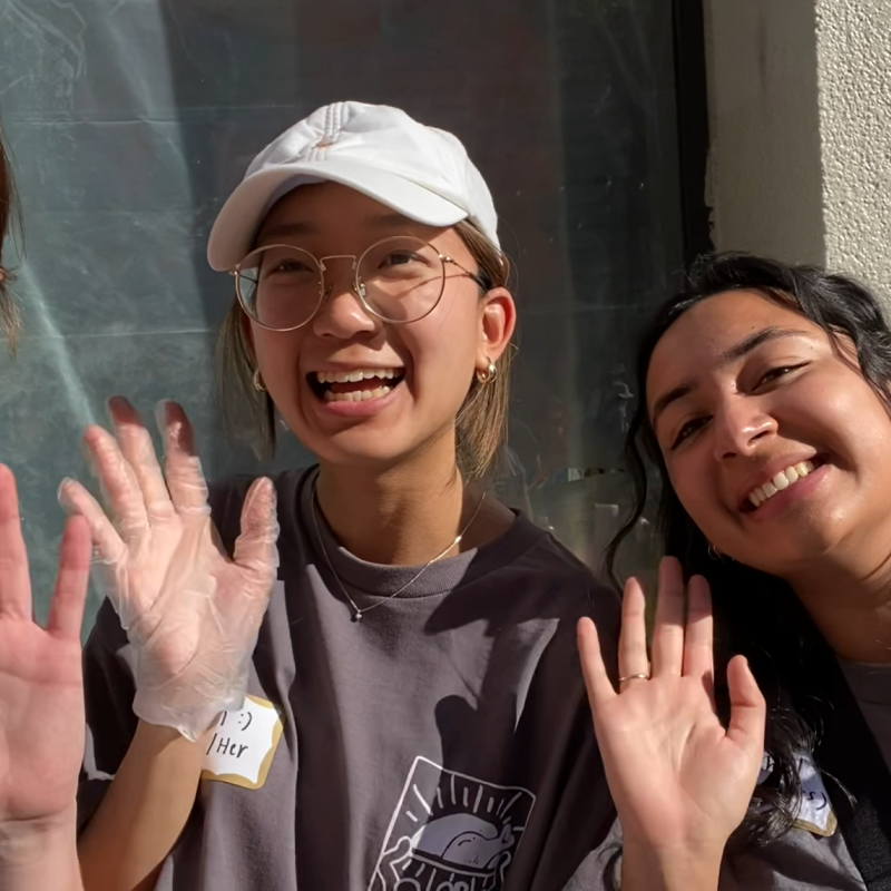 three people are in the photo - Catherine (left), Fern (middle), Rachel (right). All three are waving at the camera and smiling. 