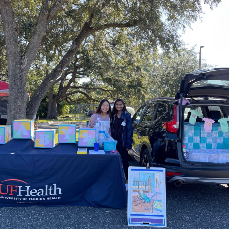 Pictured is Binta Patel and Katelyn Griffen, current NHC FL members, tabling for their host site. 