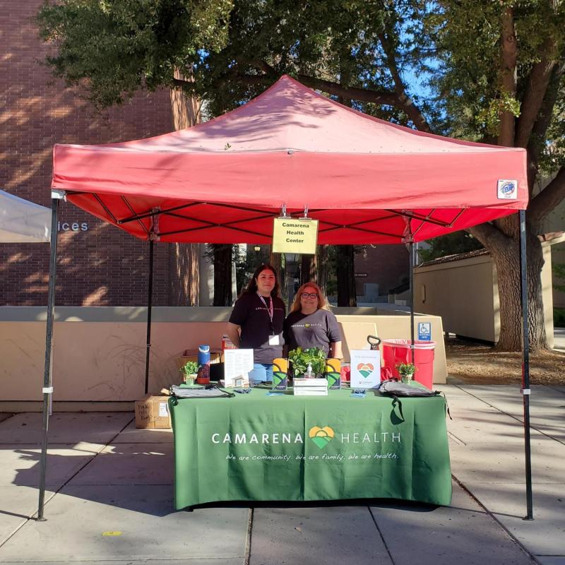 Martha tabling at a fair for Camarena Health
