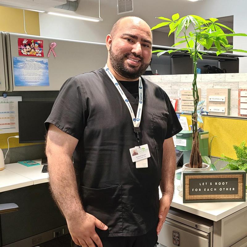 Abraham Housini in his cubicle with his plants