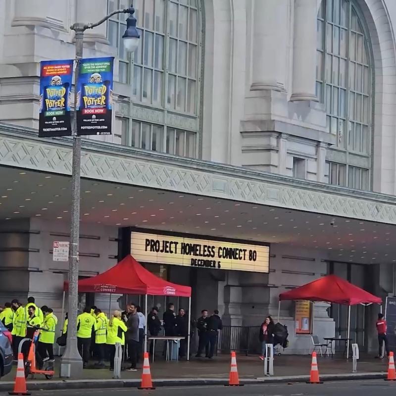 A photo of the entrance of Bill Graham Civic Auditorium. On the sign at the front of the entrance reads "Project Homeless Connect."